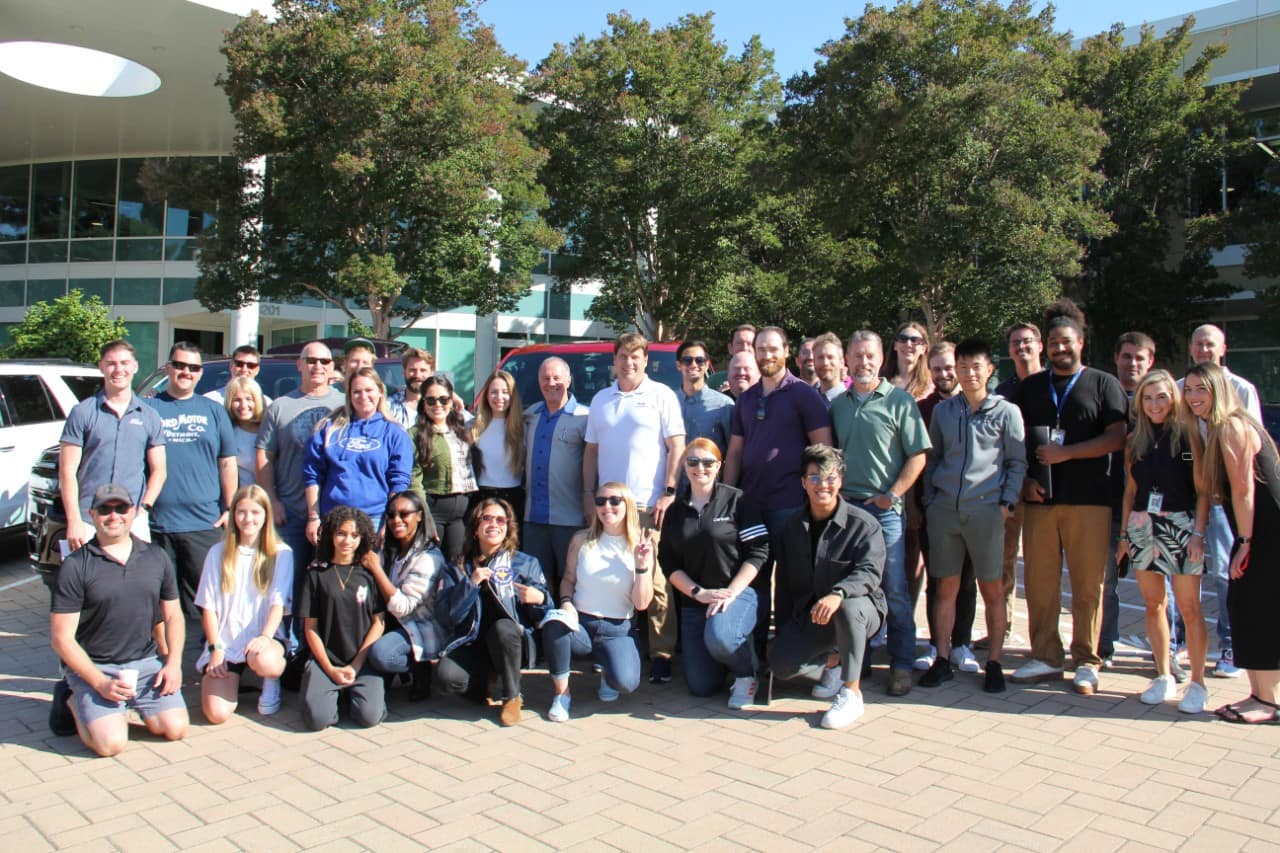 A large group of people smile for a photo.